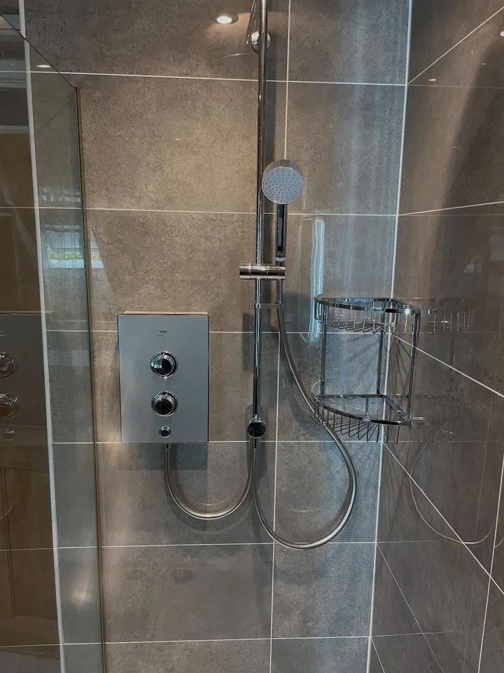 A Mira shower fitted into a tiled enclosure on a Cardiff bathroom refit