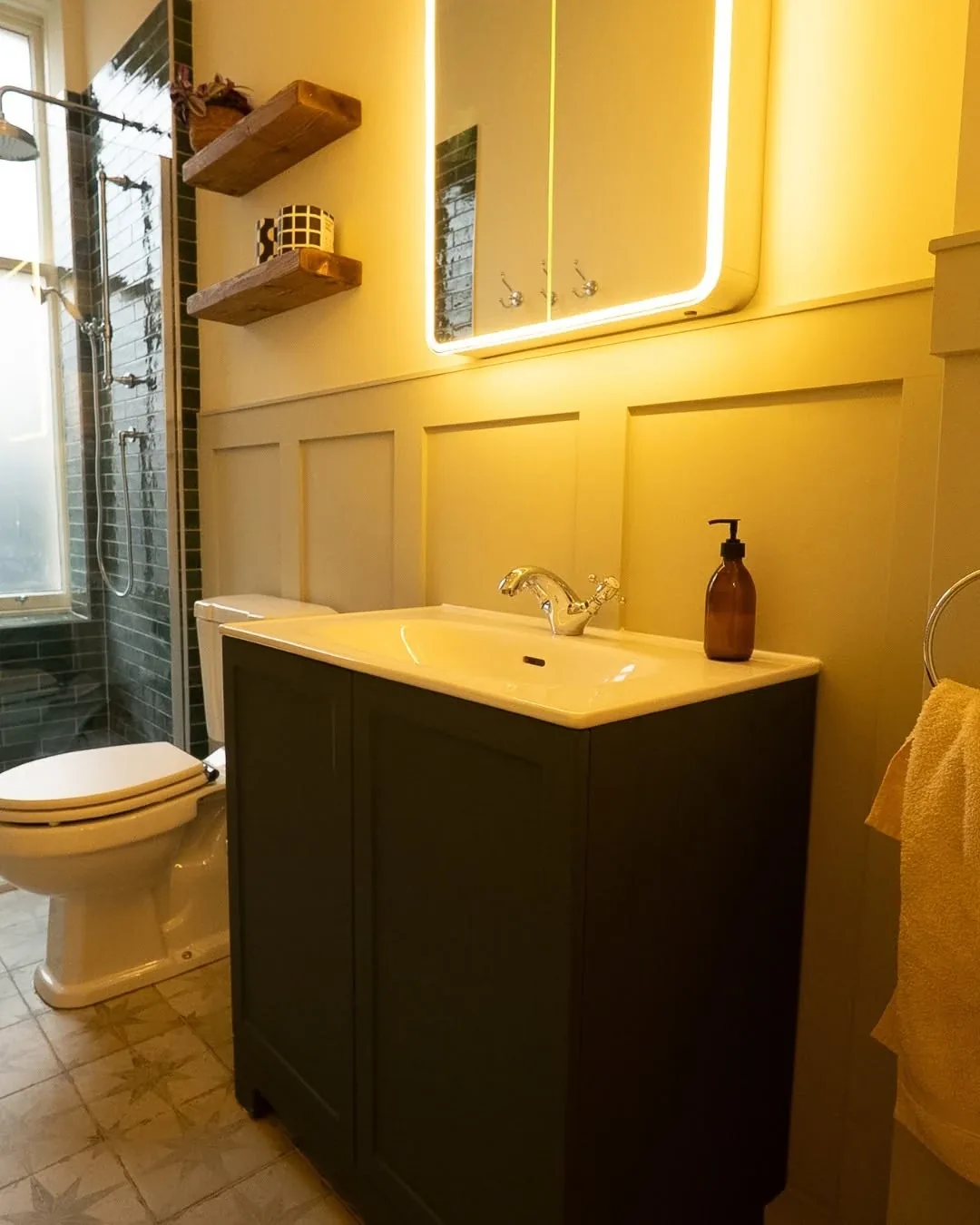 Dark green vanity unit with basin and an LED mirror cabinet on a Cardiff bathroom fit